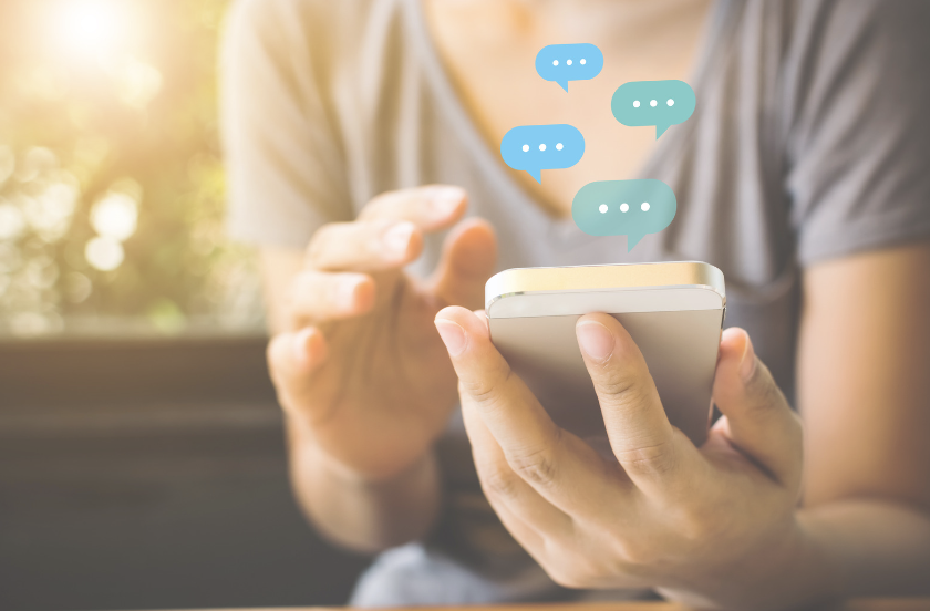 Image of a woman receiving messages on her mobile phone.