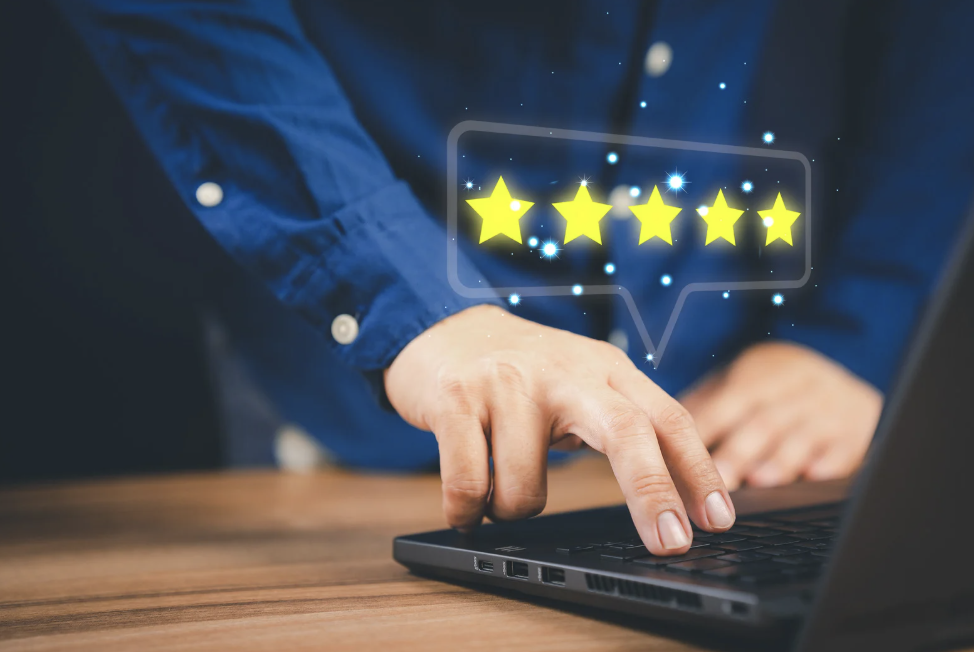 A computer with five review-style stars coming out of it